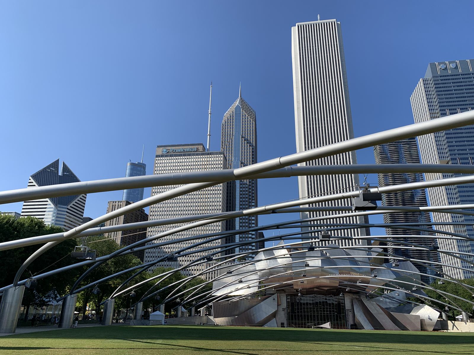 The Jay Pritzker Pavilion in Millennium Park against the skyscrapers