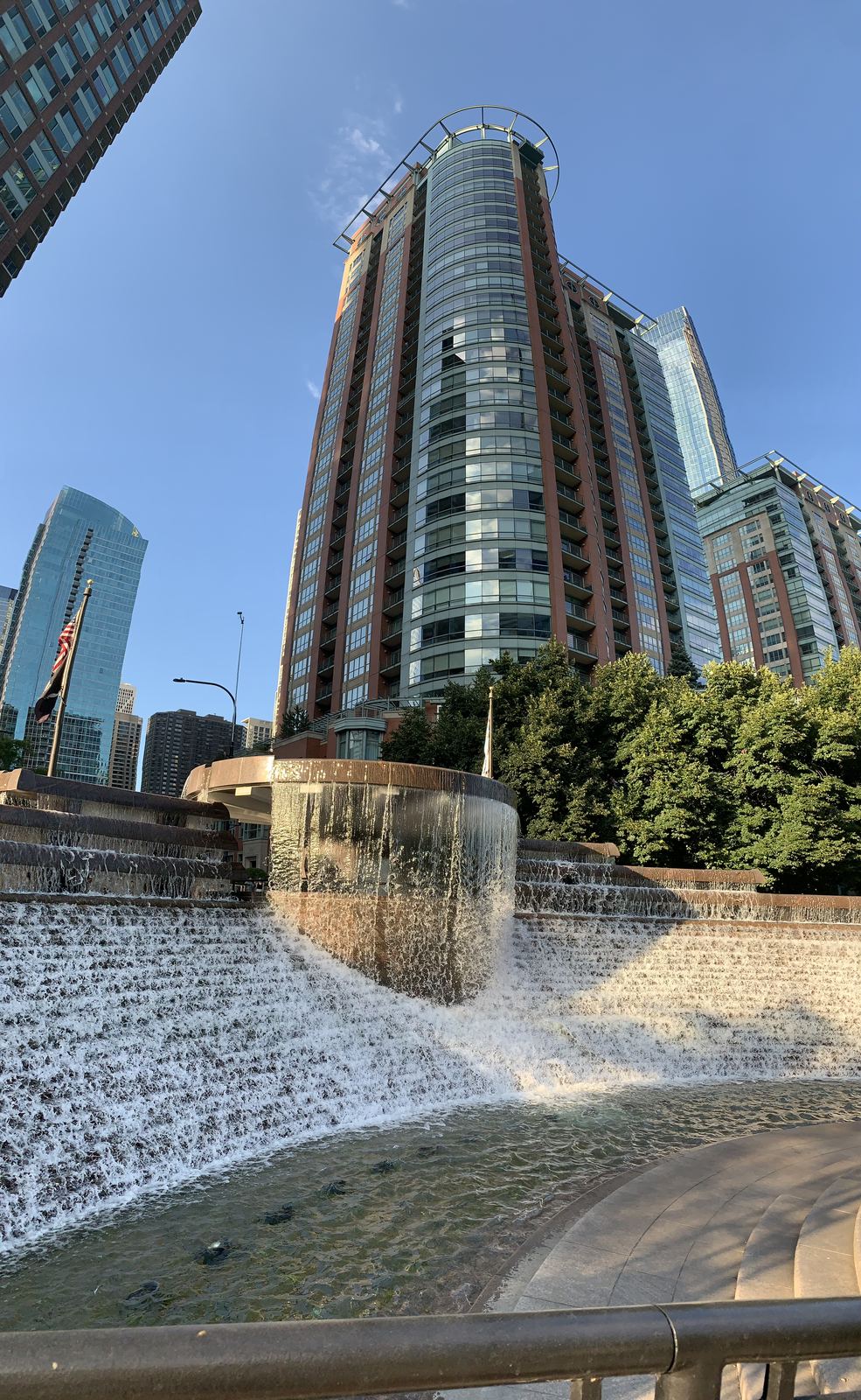 A cascading fountain on the riverwalk against a residential high-rise